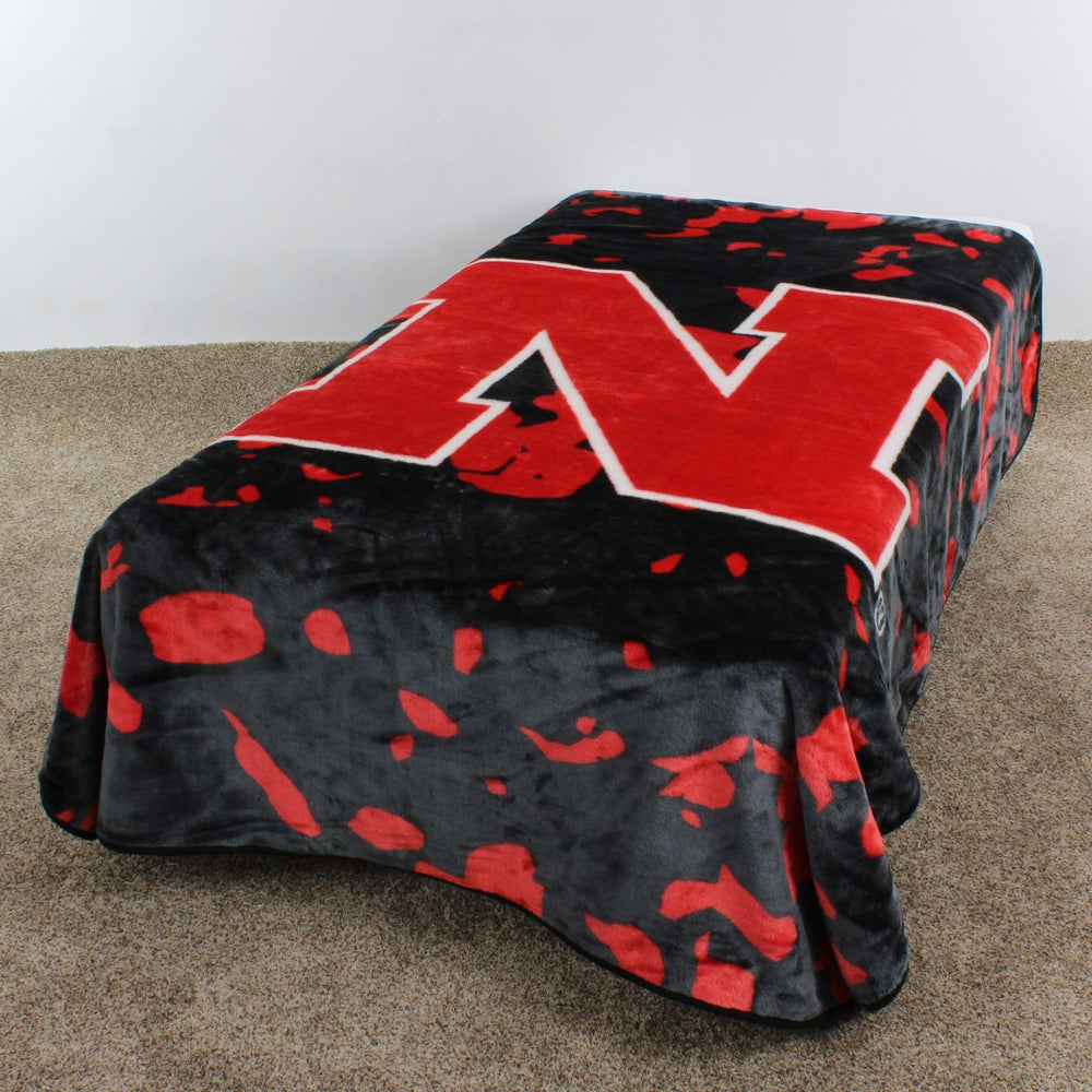 86"x63" NCAA Cornhuskers Throw Blanket Sports Football Bedspread Team Logo - Diamond Home USA